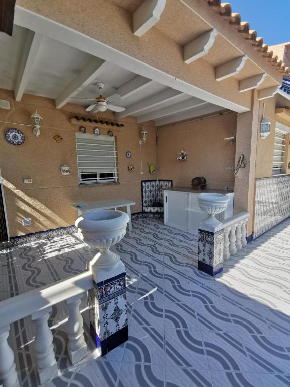 Patio with terracotta tiles and white balustrades in Arenales Del Sol
