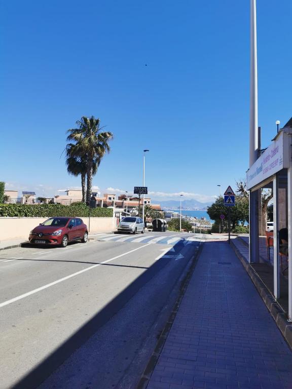 Street in Arenales Del Sol with palm tree and Mediterranean view